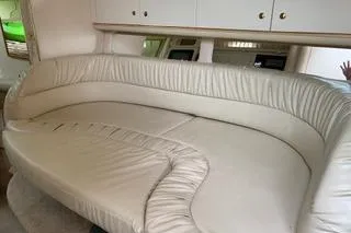 Slide: The Image of Interior seating of Sea Ray 340 Sundancer boat, featuring cream leather upholstery. - 4