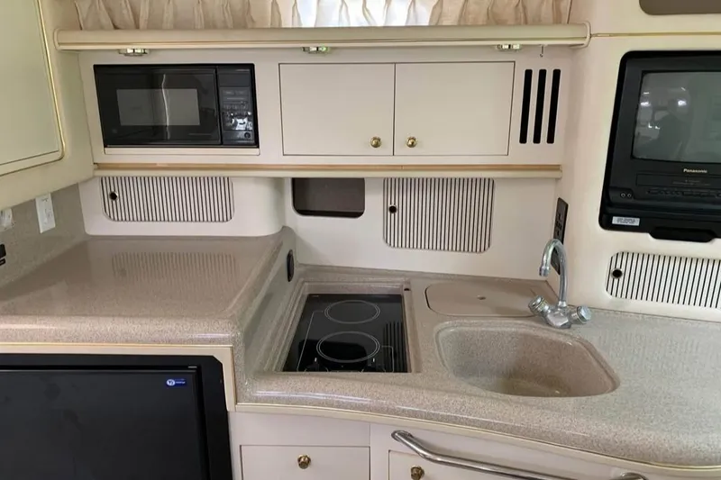 Slide: The Image of Interior of a 2000 Sea Ray 340 Sundancer yacht kitchen with appliances and sink. - 7