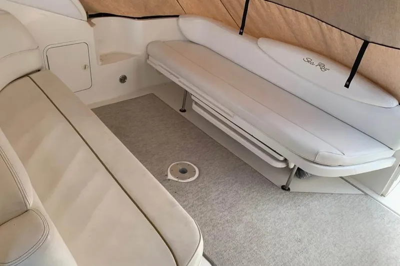 Slide: The Image of Interior seating of 2000 Sea Ray 340 Sundancer boat with beige upholstery. - 9