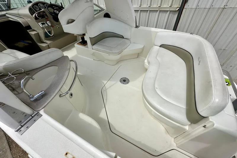 Slide: The Image of 2006 Sea Ray 260 Sundancer boat interior with seating and helm. - 14