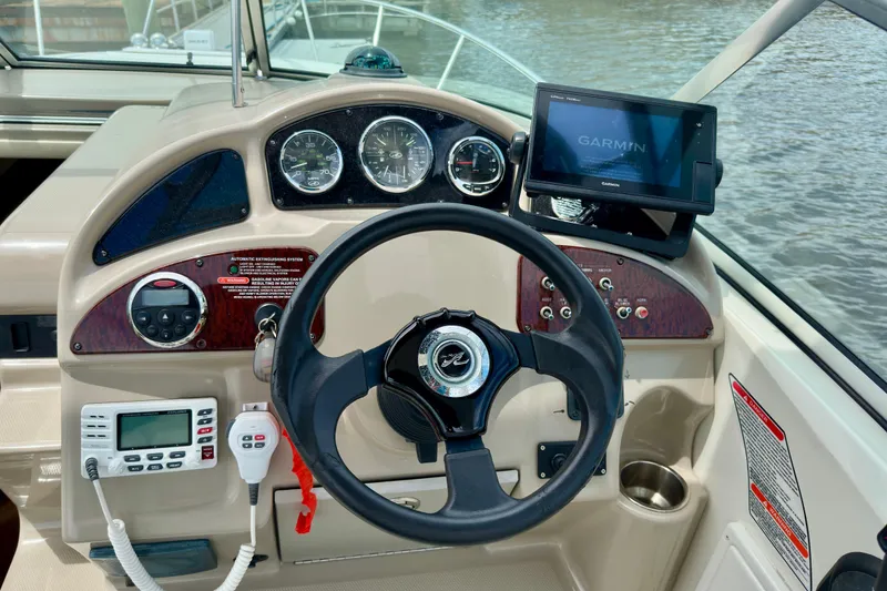 Slide: The Image of Cockpit of 2006 Sea Ray 260 Sundancer with Garmin navigation system and control panel. - 24