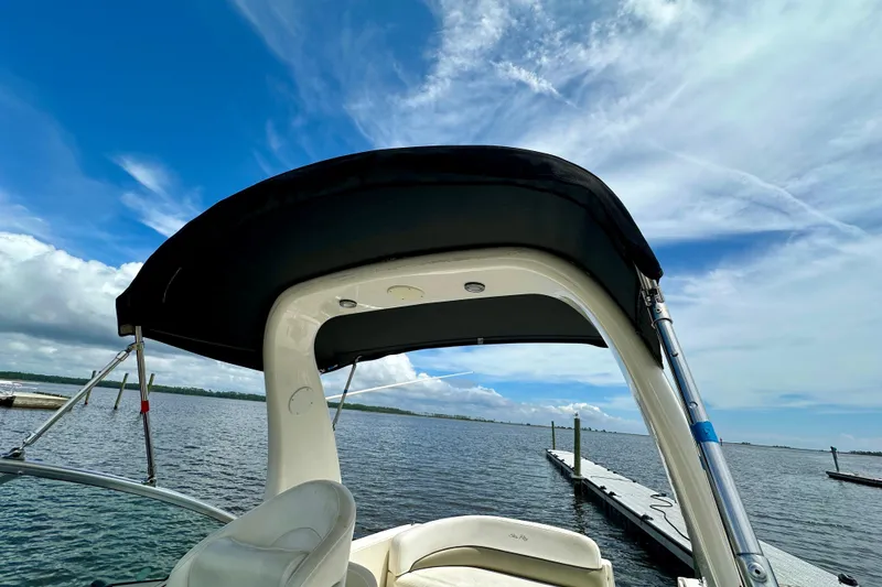 Slide: The Image of 2006 Sea Ray 260 Sundancer boat with canopy on a sunny day at the dock. - 25