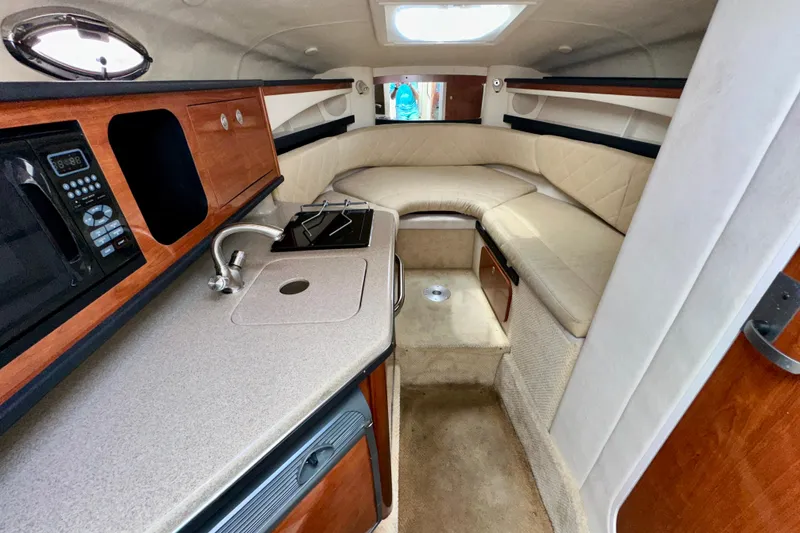 Slide: The Image of Interior of 2006 Sea Ray 260 Sundancer with kitchenette and seating area. - 29
