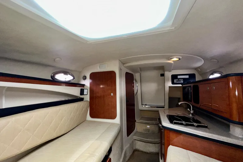 Slide: The Image of Interior of 2006 Sea Ray 260 Sundancer boat with kitchenette and seating area. - 33