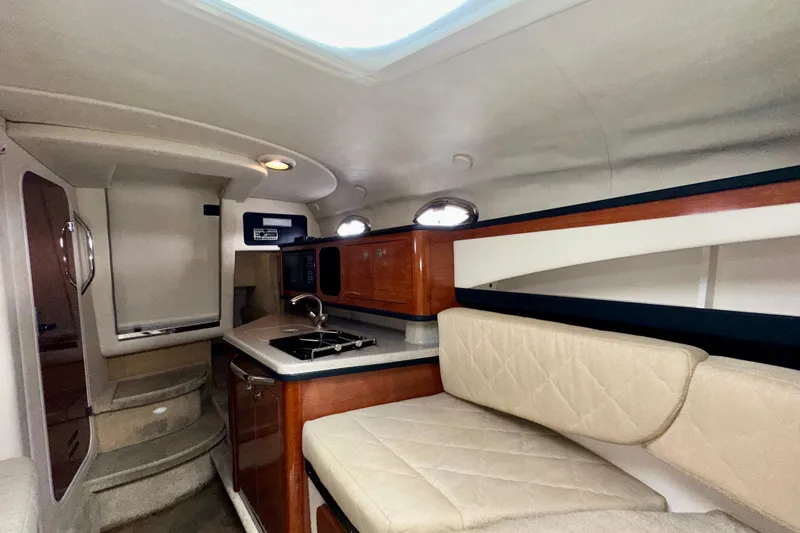 Slide: The Image of Interior of 2006 Sea Ray 260 Sundancer with kitchenette and seating area. - 34
