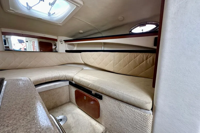 Slide: The Image of Interior cabin of a 2006 Sea Ray 260 Sundancer with beige seating and overhead hatch. - 35