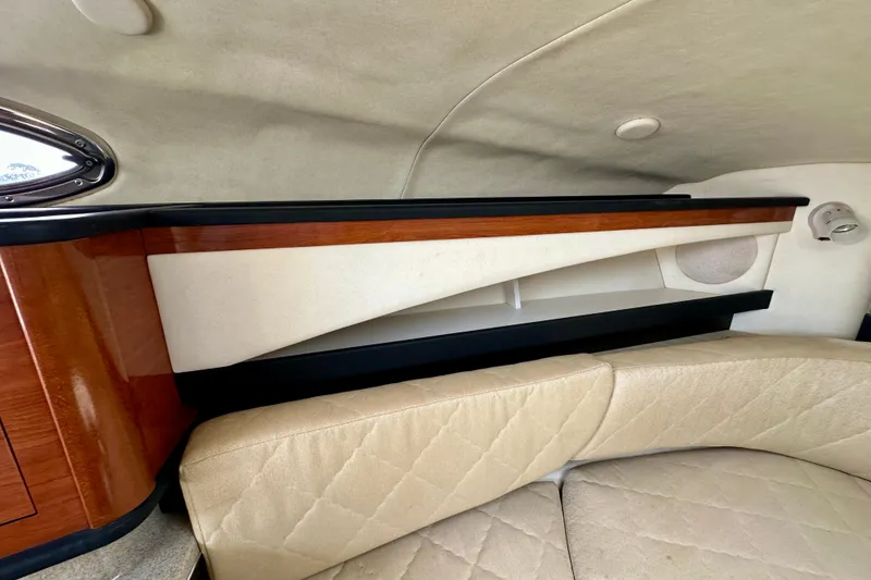 Slide: The Image of Interior of 2006 Sea Ray 260 Sundancer with beige seating and wood accents. - 41