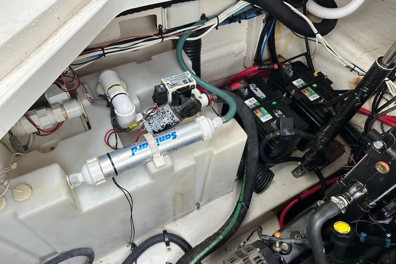 Slide: The Image of Engine compartment of a 2006 Sea Ray 260 Sundancer with batteries and wiring. - 55