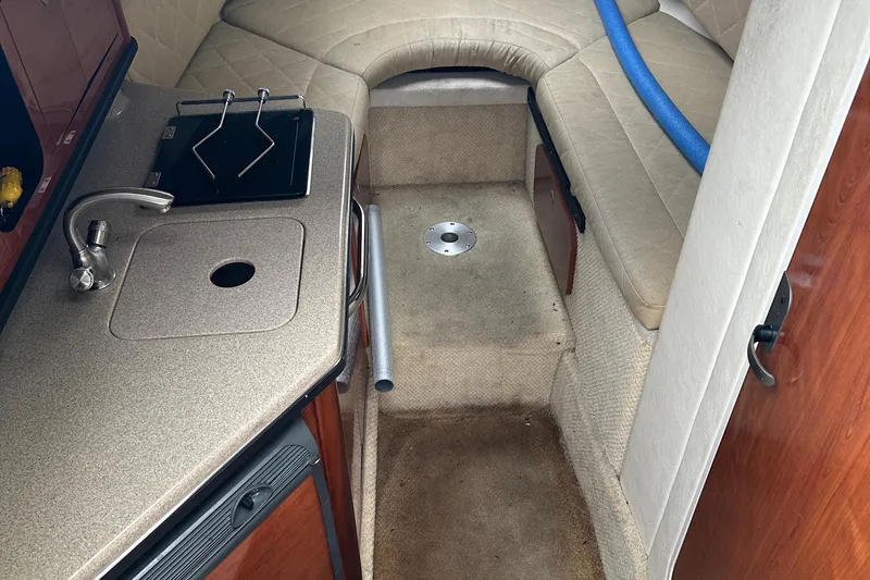 Slide: The Image of 2006 Sea Ray 260 Sundancer cabin interior with kitchenette and seating area. - 59
