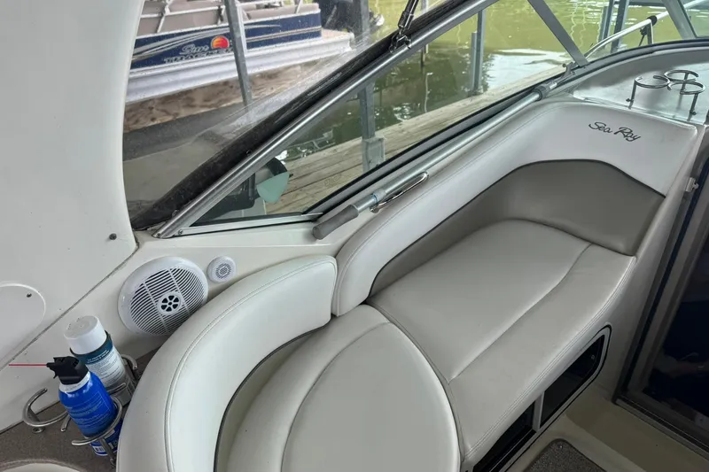 Slide: The Image of 2007 Sea Ray 260 Sundancer interior with white seating and speaker system. - 12