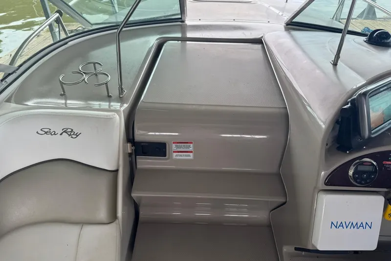 Slide: The Image of 2007 Sea Ray 260 Sundancer cockpit with Navman system and cup holders. - 17