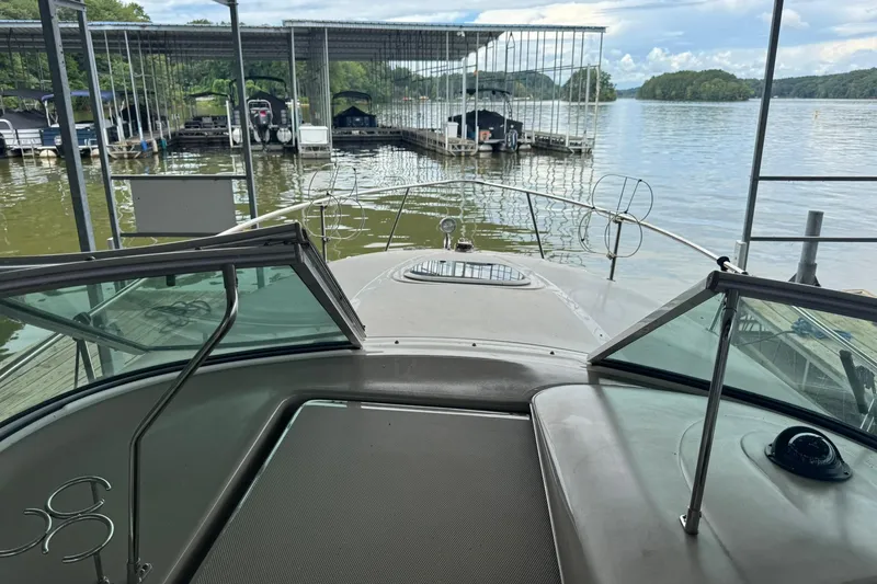 Slide: The Image of 2007 Sea Ray 260 Sundancer docked at a marina with scenic lake view. - 18