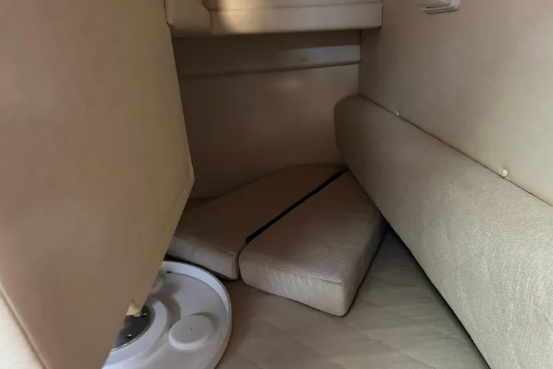 Slide: The Image of Interior cabin of 2007 Sea Ray 260 Sundancer with beige upholstery and seating area. - 23
