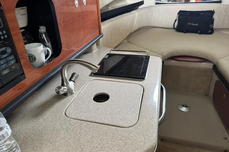 Slide: The Image of Interior of 2007 Sea Ray 260 Sundancer with kitchenette and seating area. - 25