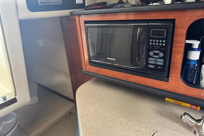 Slide: The Image of 2007 Sea Ray 260 Sundancer interior with microwave and countertop amenities. - 26