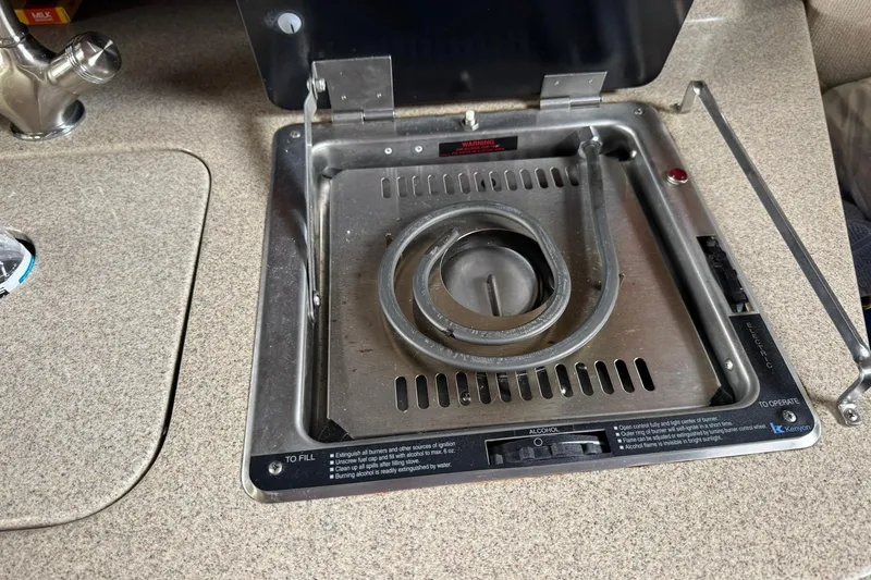 Slide: The Image of 2007 Sea Ray 260 Sundancer boat stove with stainless steel burner and countertop. - 28