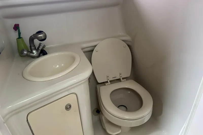 Slide: The Image of Compact bathroom in 2007 Sea Ray 260 Sundancer boat with sink and toilet. - 30