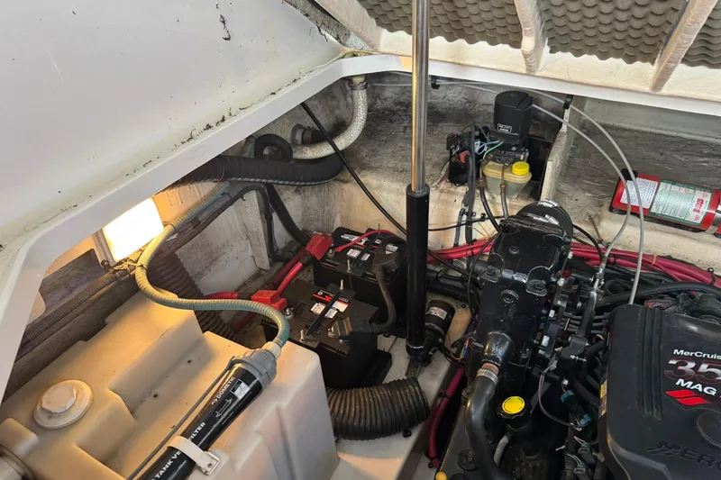 Slide: The Image of Engine compartment of a 2007 Sea Ray 260 Sundancer with batteries and MerCruiser components. - 33