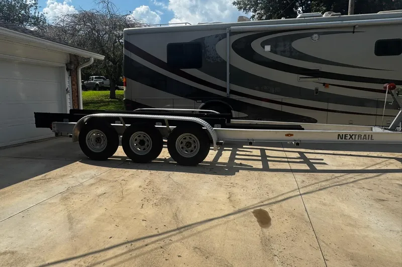 Slide: The Image of Trailer parked on driveway beside RV, suitable for 2007 Sea Ray 260 Sundancer. - 39