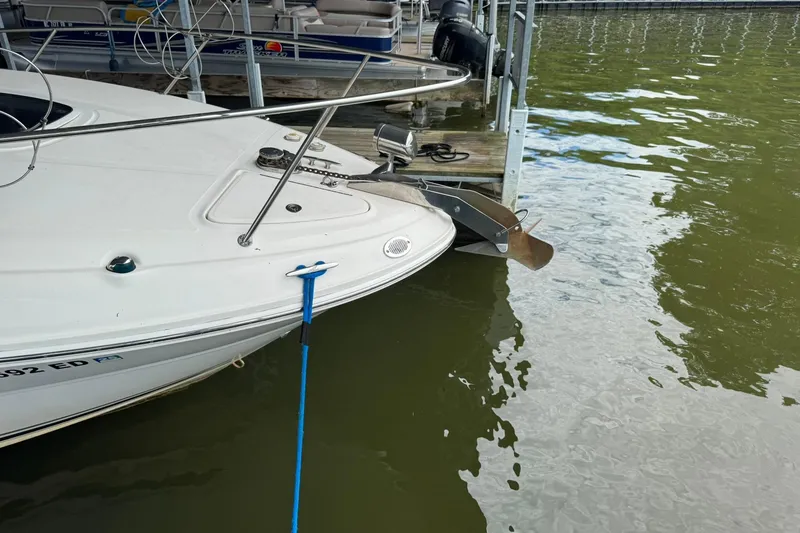 Slide: The Image of 2007 Sea Ray 260 Sundancer docked, showing bow and anchor, with blue mooring line. - 5