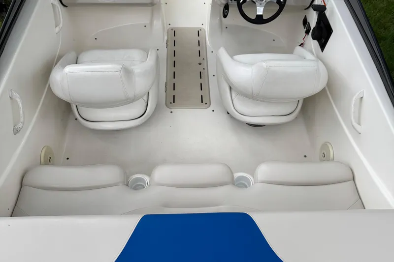 Slide: The Image of 2008 Glastron MX175 boat interior with white seating and steering wheel. - 10