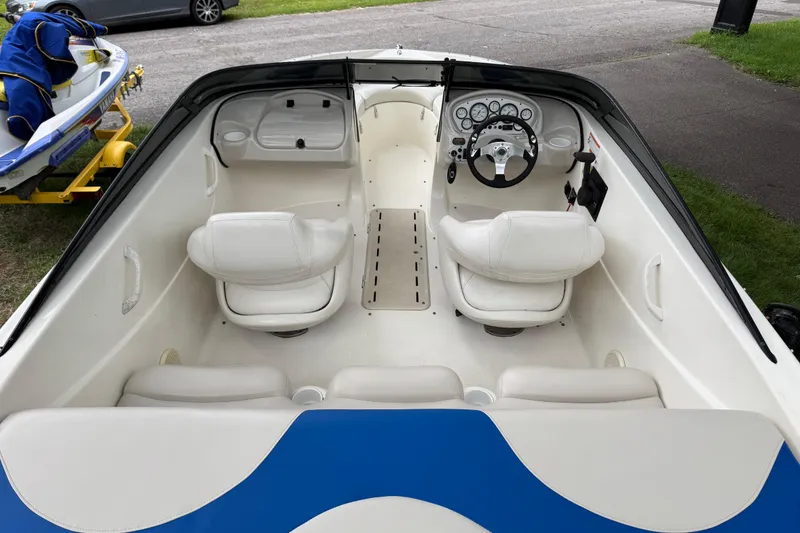 Slide: The Image of 2008 Glastron MX175 boat interior with white seating and steering wheel. - 7