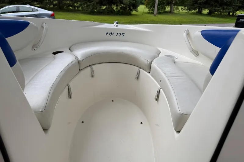 Slide: The Image of 2008 Glastron MX175 boat interior with white seating and blue accents. - 8