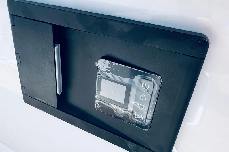 Slide: The Image of Control panel on 2026 Monterey Elite 30 OB boat, featuring a sleek black design. - 11