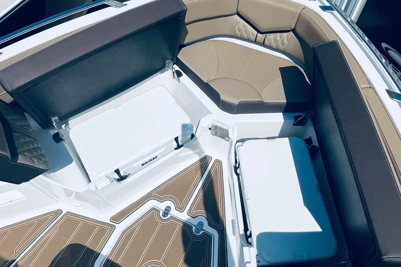 Slide: The Image of Interior of 2026 Monterey Elite 30 OB boat with seating and storage compartments. - 13