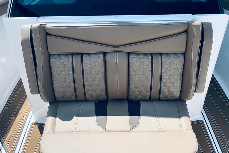Slide: The Image of Luxurious seating on 2026 Monterey Elite 30 OB boat with diamond-stitched upholstery. - 14