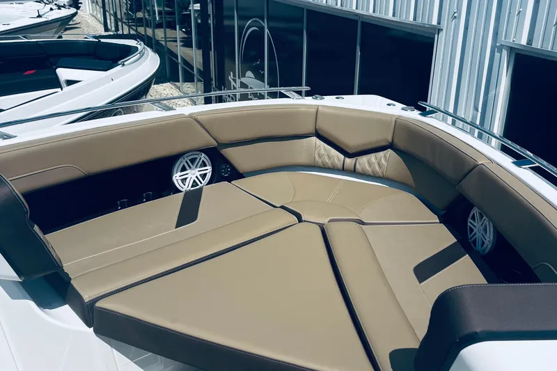 Slide: The Image of Luxurious seating area on a 2026 Monterey Elite 30 OB boat, featuring tan upholstery. - 17