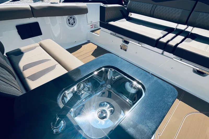 Slide: The Image of Luxury seating and sink on 2026 Monterey Elite 30 OB boat interior. - 19