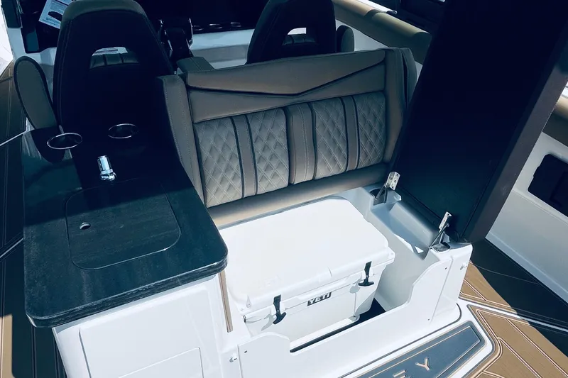 Slide: The Image of Interior of 2026 Monterey Elite 30 OB boat with seating and storage. - 20