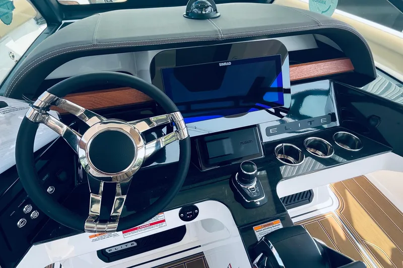 Slide: The Image of Cockpit of 2026 Monterey Elite 30 OB boat with modern steering and controls. - 8