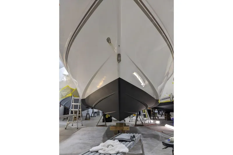 Slide: The Image of 1998 Four Winns 240 Horizon boat in a workshop, viewed from below. - 10