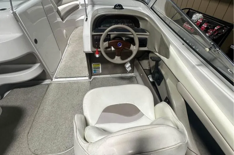 Slide: The Image of 1998 Four Winns 240 Horizon boat interior with steering wheel and seating area. - 15