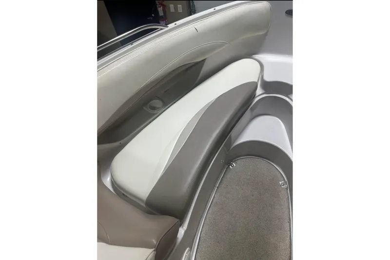 Slide: The Image of 1998 Four Winns 240 Horizon boat interior seating, featuring gray and white upholstery. - 17
