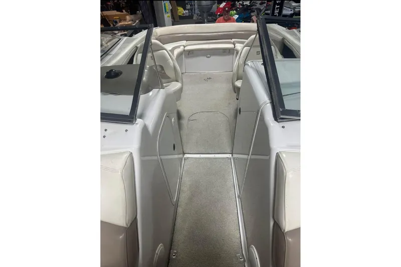 Slide: The Image of 1998 Four Winns 240 Horizon boat interior with beige seating and carpeted floor. - 19