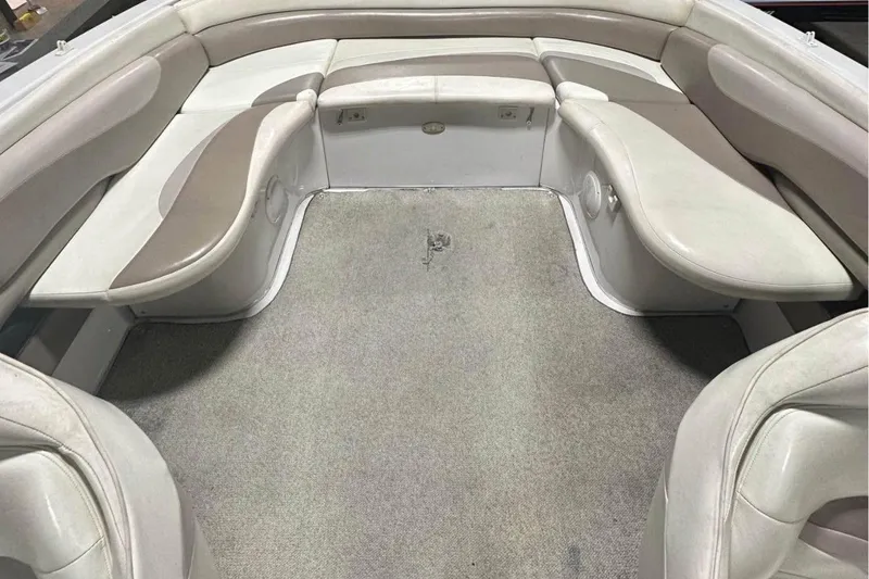 Slide: The Image of Interior seating of a 1998 Four Winns 240 Horizon boat, featuring beige upholstery. - 20
