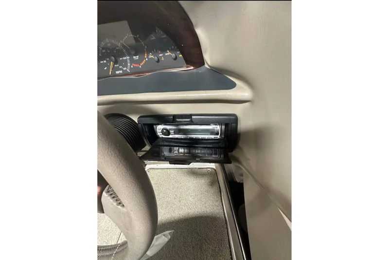 Slide: The Image of 1998 Four Winns 240 Horizon dashboard with stereo system and instrument panel. - 22