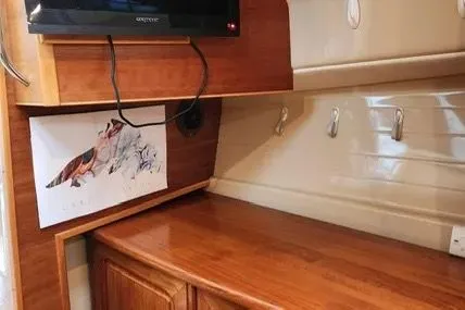 Slide: The Image of Interior of 2013 Cutwater C-26 boat with wooden cabinetry and mounted TV. - 14