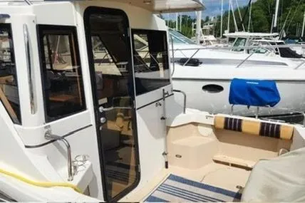 Slide: The Image of 2013 Cutwater C-26 boat docked, featuring a cozy cockpit and sleek design. - 2