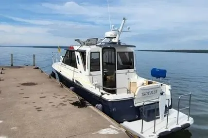 Slide: The Image of 2013 Cutwater C-26 boat docked at a pier on a calm lake. - 3