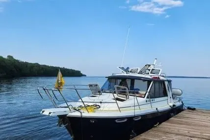 Slide: The Image of 2013 Cutwater C-26 boat docked on a serene lake under a clear blue sky. - 4