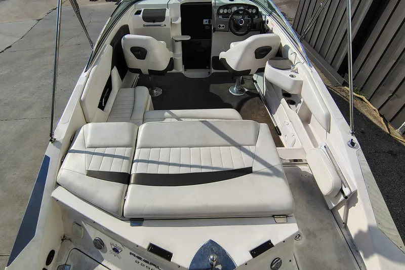 Slide: The Image of 2006 Regal 2250 Cuddy boat interior with white seating and modern dashboard. - 10