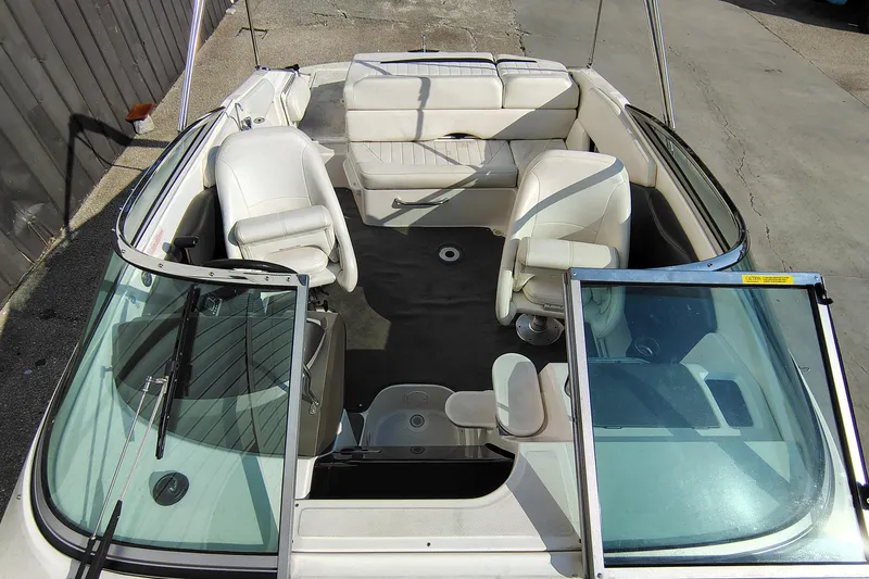 Slide: The Image of 2006 Regal 2250 Cuddy boat interior with white seating and open windshield. - 14