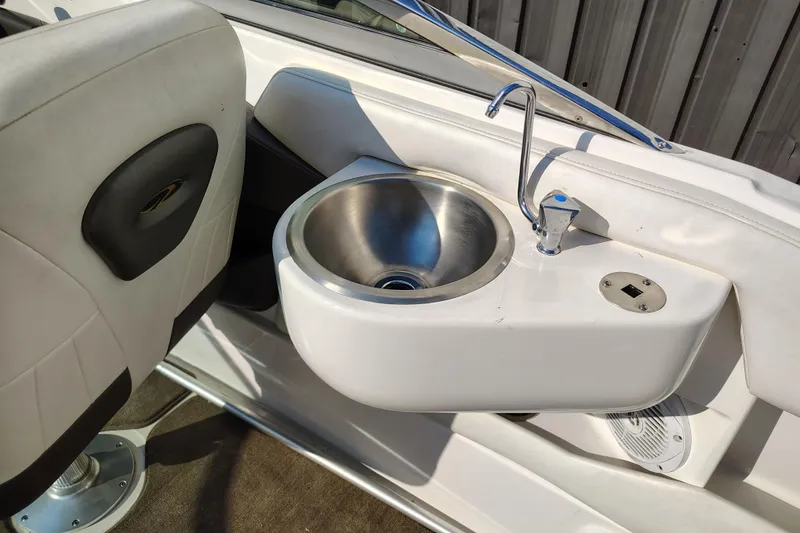 Slide: The Image of 2006 Regal 2250 Cuddy boat interior with sink and seating detail. - 15