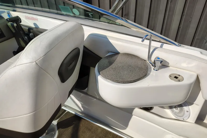 Slide: The Image of 2006 Regal 2250 Cuddy boat interior with sink and seating area. - 16