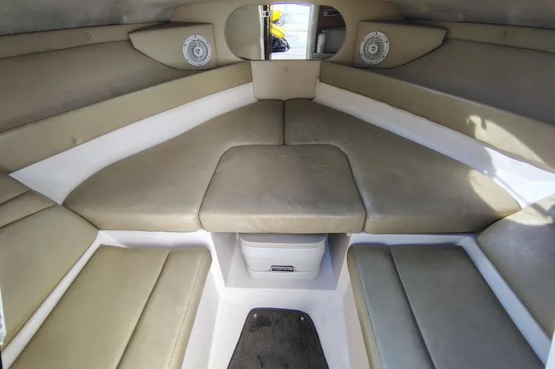 Slide: The Image of Interior of 2006 Regal 2250 Cuddy boat with beige seating and speakers. - 17