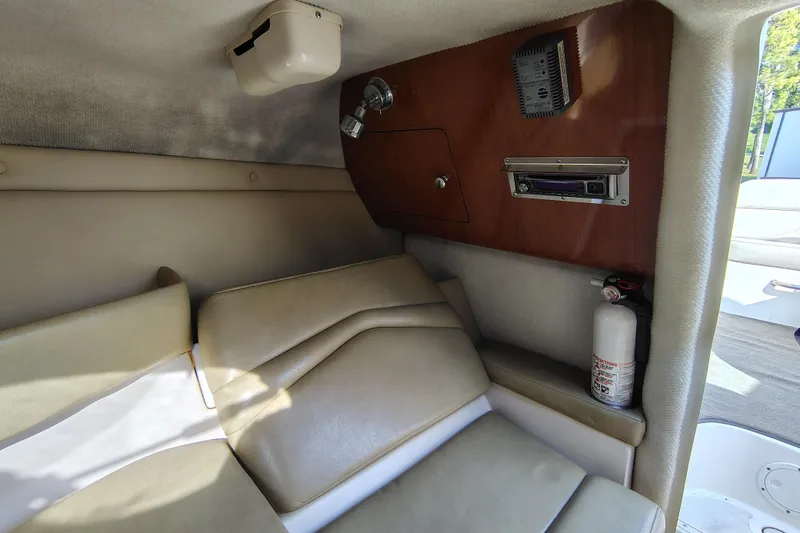 Slide: The Image of 2006 Regal 2250 Cuddy cabin interior with seating, fire extinguisher, and audio system. - 18